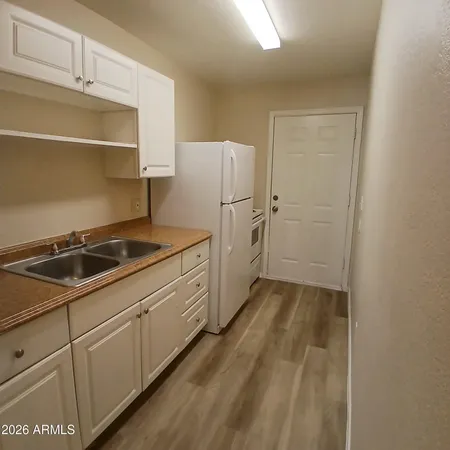 a kitchen with a sink and cabinets