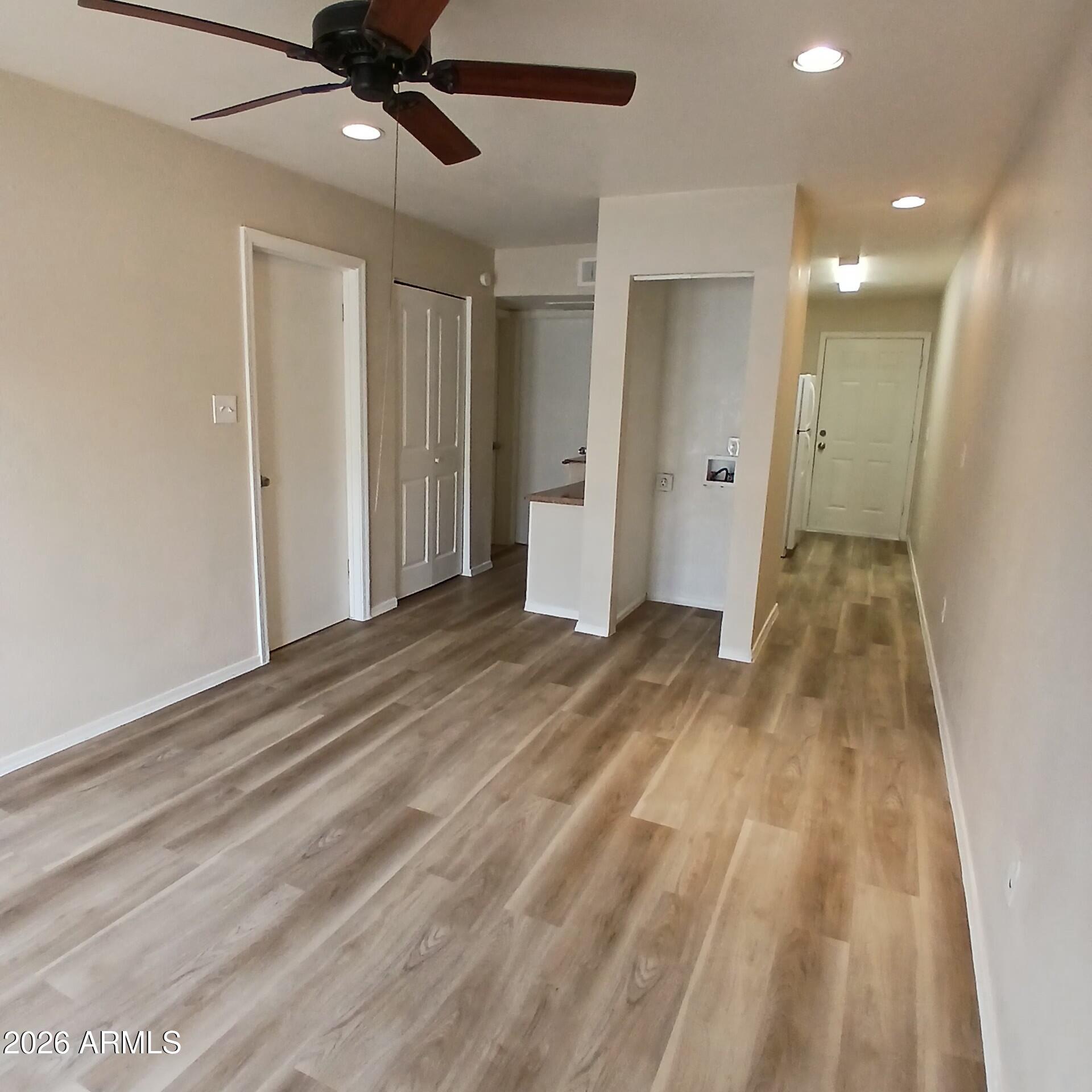 1216 West Purdue Avenue, Unit 3 Phoenix, AZ 85021 - Photo 5 of 14 a view of empty room with wooden floor
