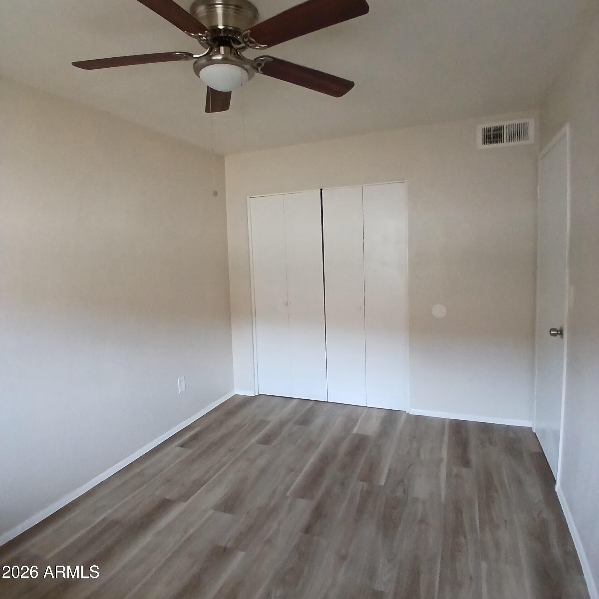 1216 West Purdue Avenue, Unit 3 Phoenix, AZ 85021 - Photo 8 of 14 wooden floor in an empty room