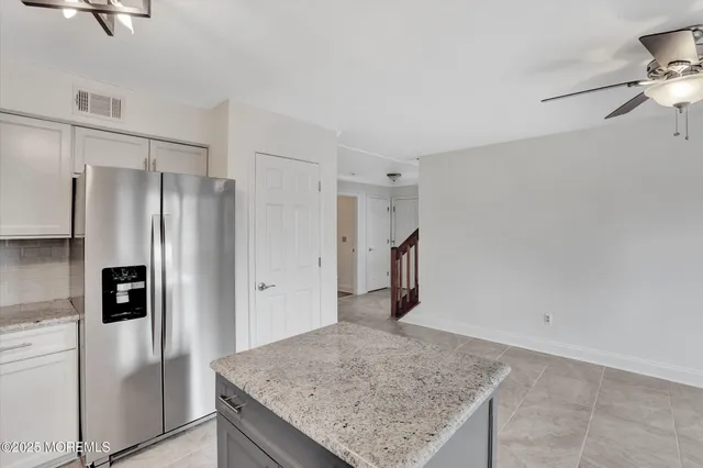 a kitchen with stainless steel appliances granite countertop a refrigerator and a sink