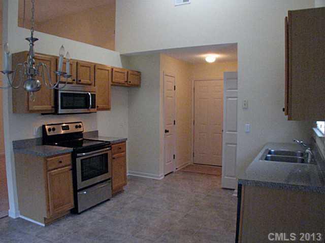 13423 Phillips Road Matthews, NC 28105 - Photo 3 of 11 a kitchen with stainless steel appliances granite countertop a stove and a refrigerator