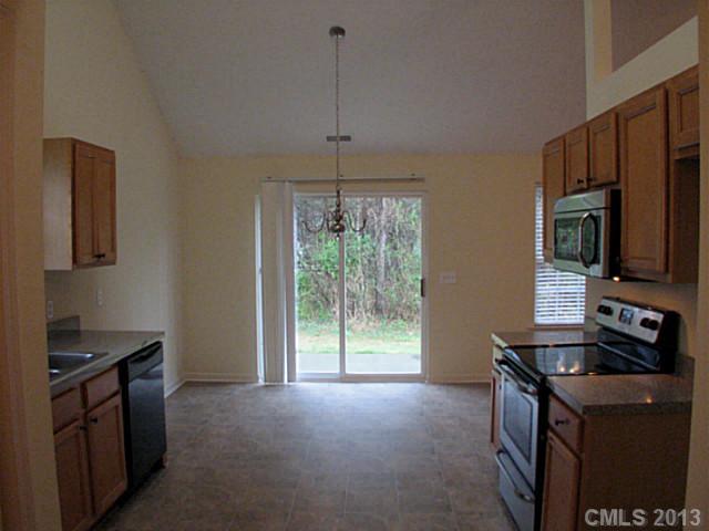 13423 Phillips Road Matthews, NC 28105 - Photo 4 of 11 a kitchen that has a sink a stove and a microwave