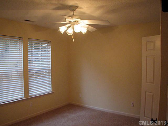 13423 Phillips Road Matthews, NC 28105 - Photo 8 of 11 en empty room with window and chandelier fan
