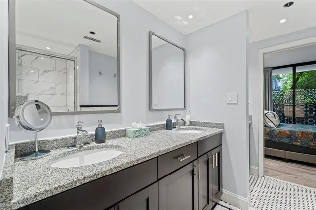 a view of a hallway with the closet and a mirror