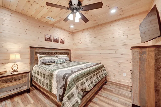 a bedroom with a bed and a ceiling fan