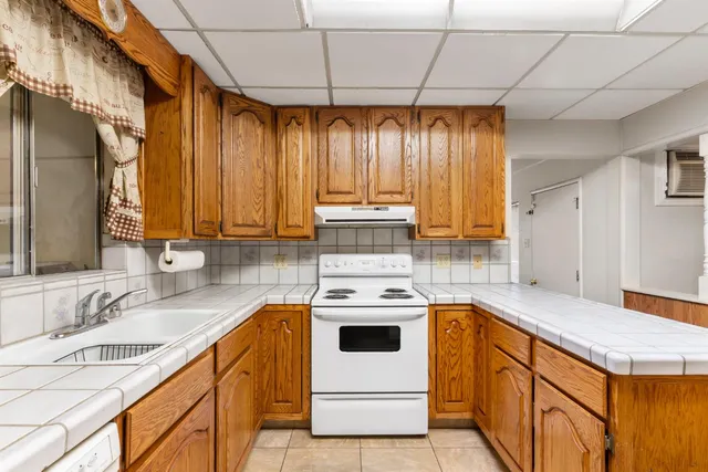 a kitchen with a stove a sink and a refrigerator