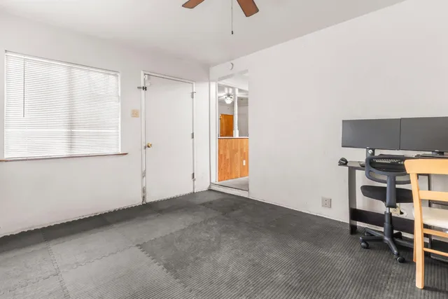 a view of workspace with window and cabinet