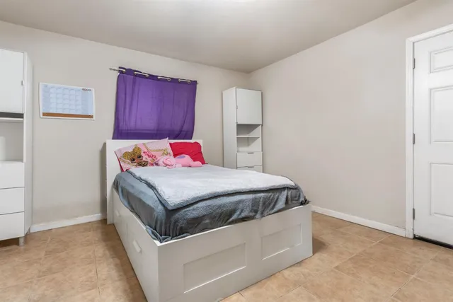 a bedroom with a bed and a dresser