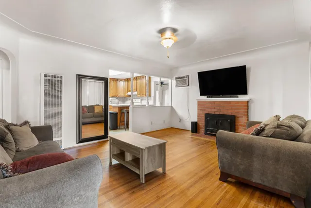 a living room with furniture a fireplace and a flat screen tv