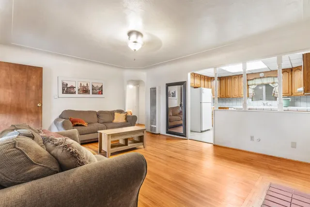 a living room with furniture and kitchen view