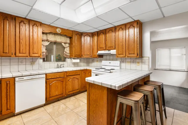 a kitchen with a sink stove and cabinets