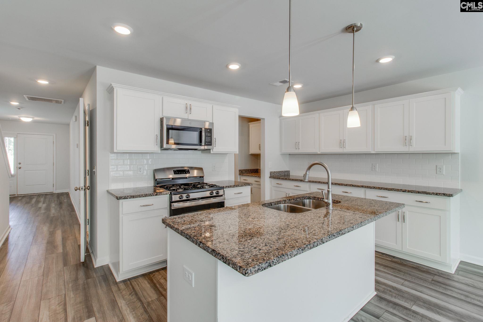 312 Reedmace Court Lexington, SC 29072 - Photo 10 of 29 a kitchen with stainless steel appliances granite countertop a sink stove and refrigerator
