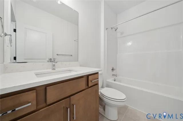 a bathroom with a sink toilet vanity and shower
