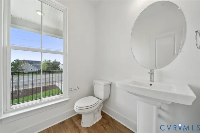 a bathroom with a toilet a sink and a window
