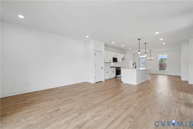 a view of kitchen with kitchen island sink and refrigerator