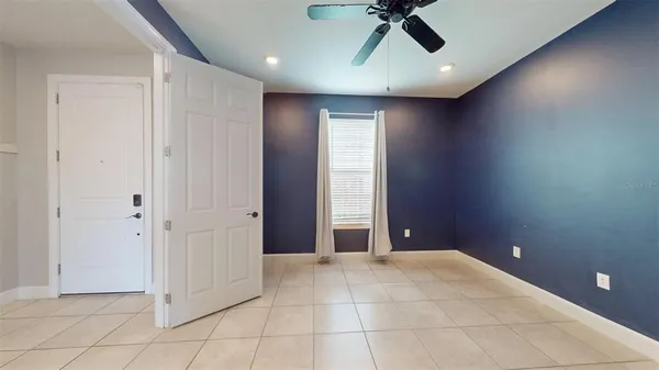 an empty room with a window and a kitchen