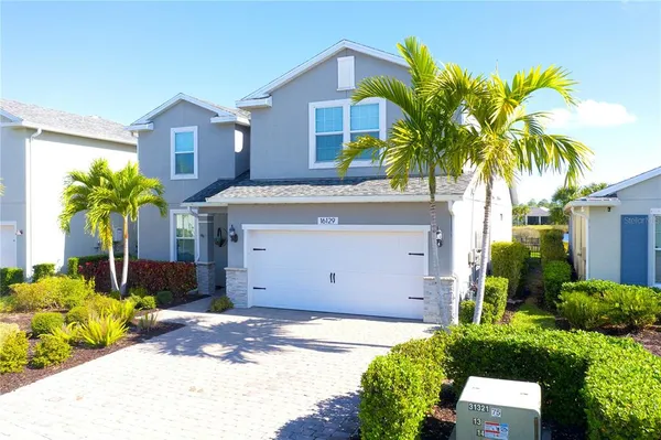 a kitchen with stainless steel appliances granite countertop a refrigerator a stove a sink and a granite counter tops