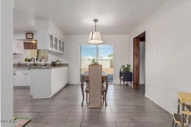 a dining room with furniture and chandelier
