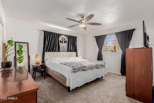 a bed sitting in a bedroom next to a window