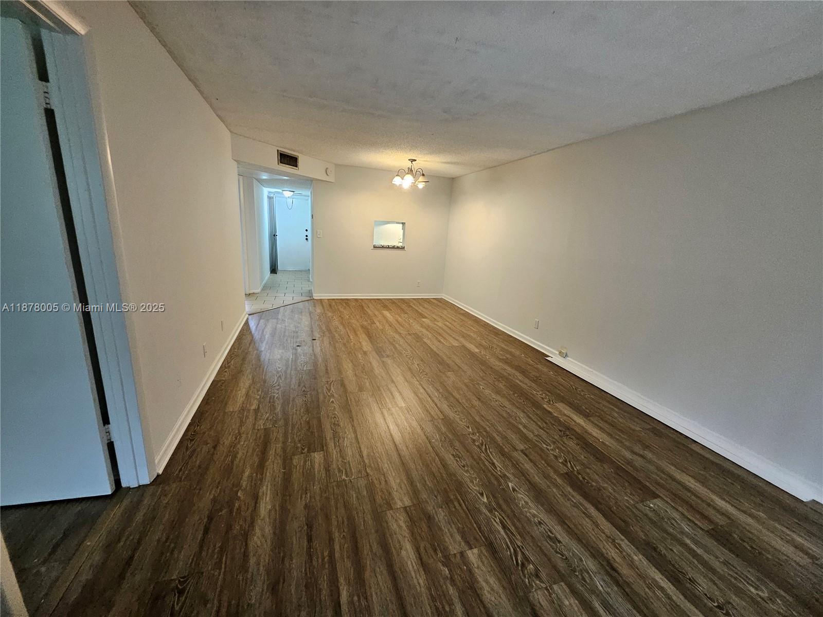 7820 South Colony Circle, Unit 102 Tamarac, FL 33321 - Photo 19 of 51 Living Room and Dining Area with Laminate wood flooring