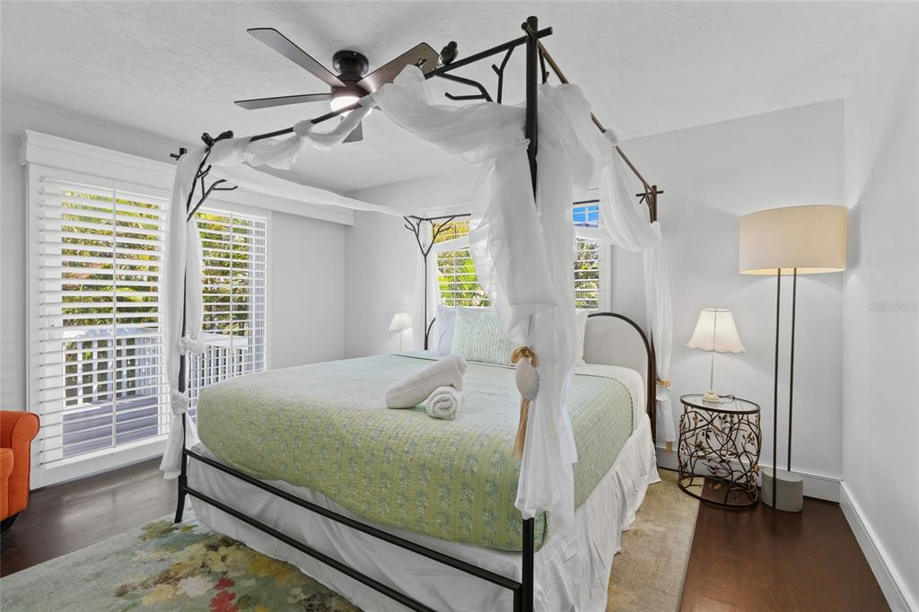 315 Spring Avenue Anna Maria, FL 34216 - Photo 31 of 63 a bedroom with a bed and a table