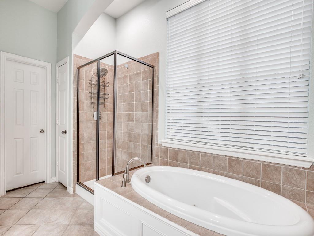 9609 Sam Bass Trail Fort Worth, TX 76244 - Photo 15 of 26 a bathroom with a bathtub and shower