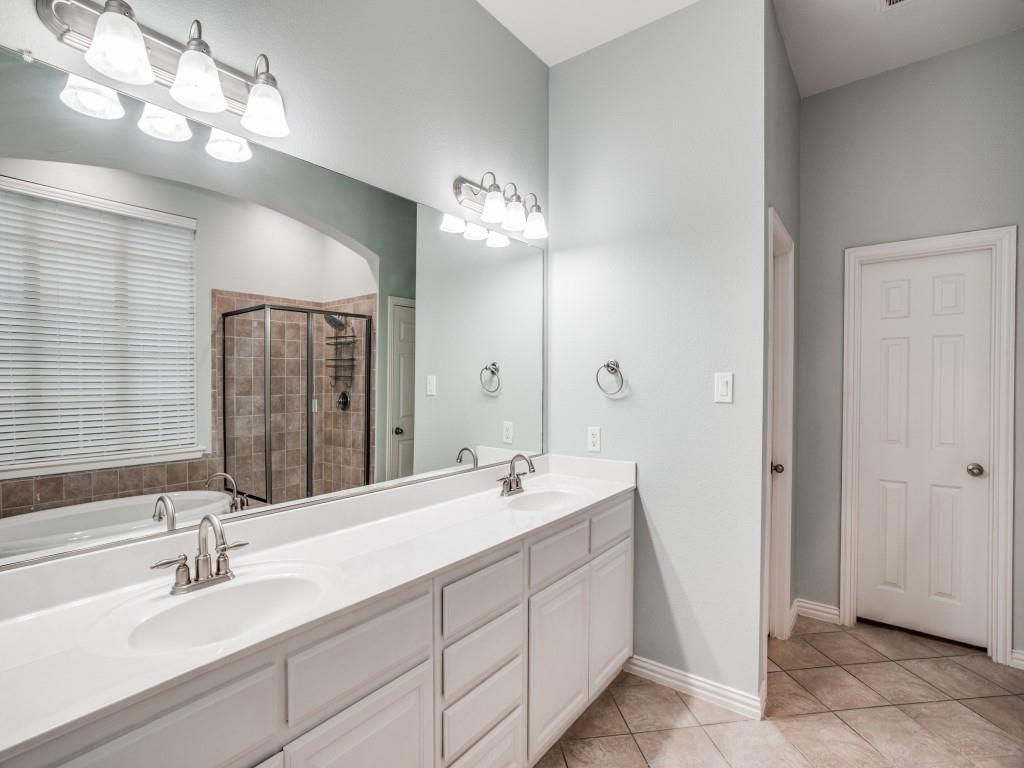 9609 Sam Bass Trail Fort Worth, TX 76244 - Photo 23 of 26 a bathroom with double vanity sink a vanity and a mirror