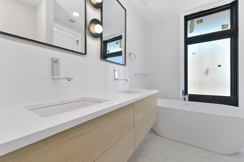 14 Green Street, Unit PH2 Brookline, MA 02446 - Photo 23 of 37 a bathroom with a sink and a mirror