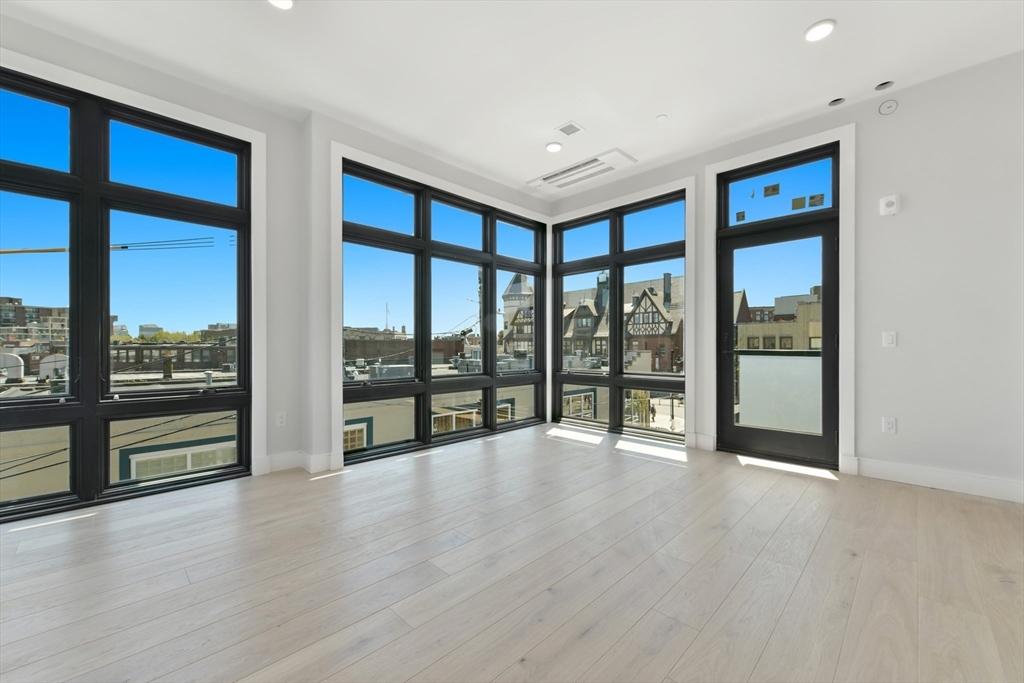 14 Green Street, Unit PH2 Brookline, MA 02446 - Photo 26 of 37 a view of an empty room with wooden floor and a window