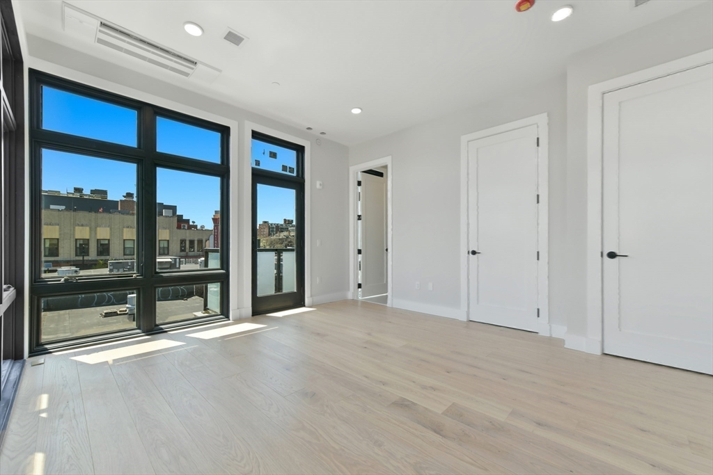14 Green Street, Unit PH2 Brookline, MA 02446 - Photo 27 of 37 a view of an empty room with a sliding door