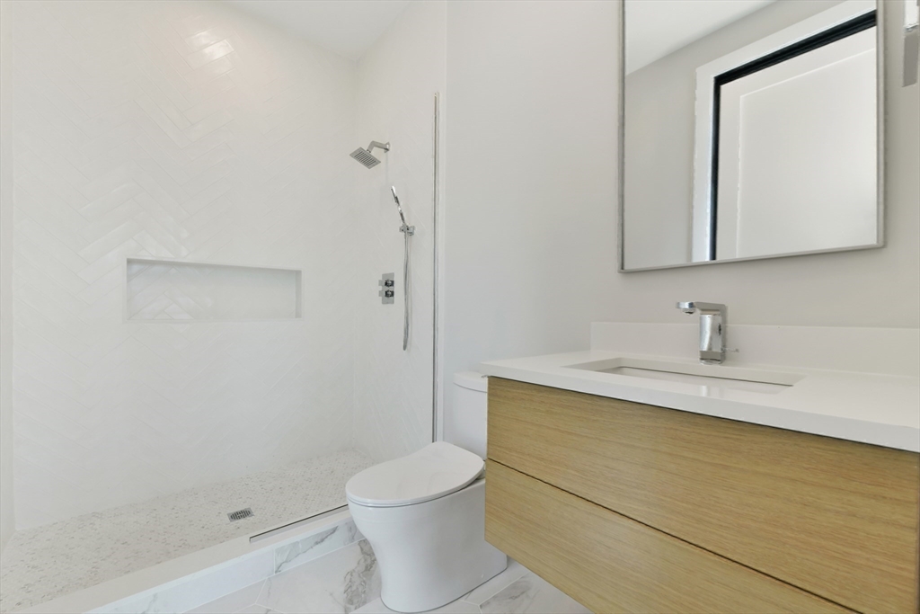 14 Green Street, Unit PH2 Brookline, MA 02446 - Photo 28 of 37 a bathroom with a sink a toilet and shower