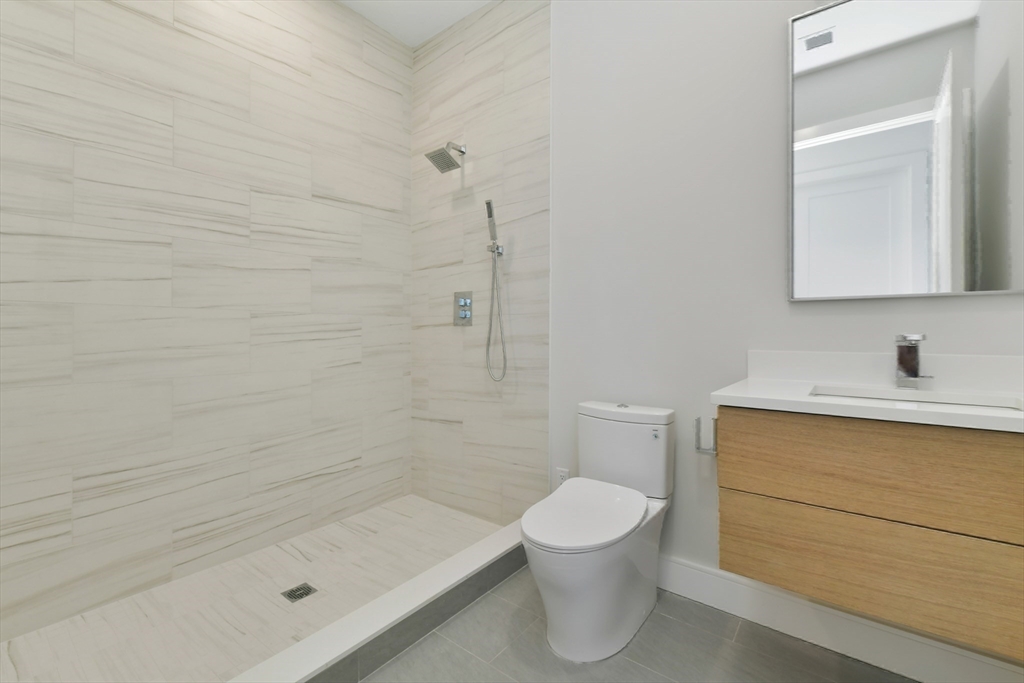 14 Green Street, Unit PH2 Brookline, MA 02446 - Photo 31 of 37 a bathroom with a sink a toilet and shower