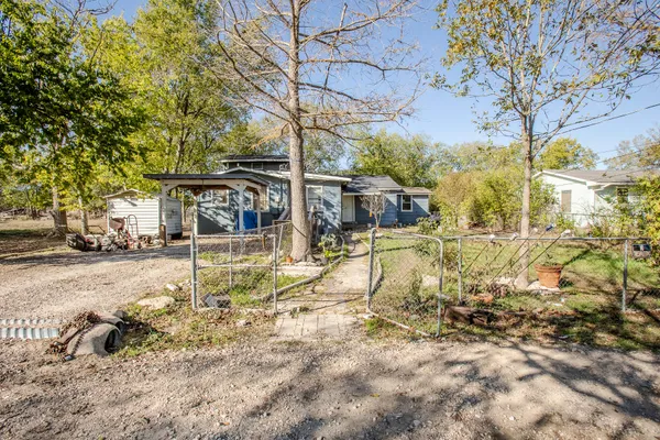 a view of a yard with wooden fence