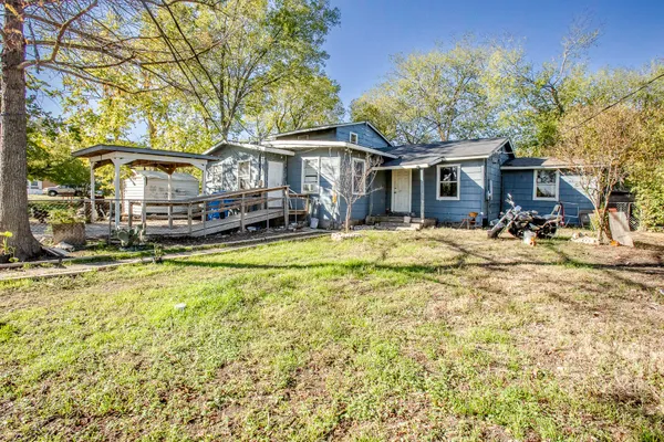 a view of a house with a yard patio and fire pit