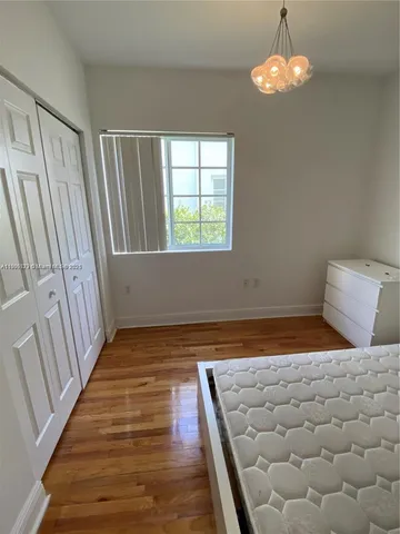 a view of room with window and hardwood floor