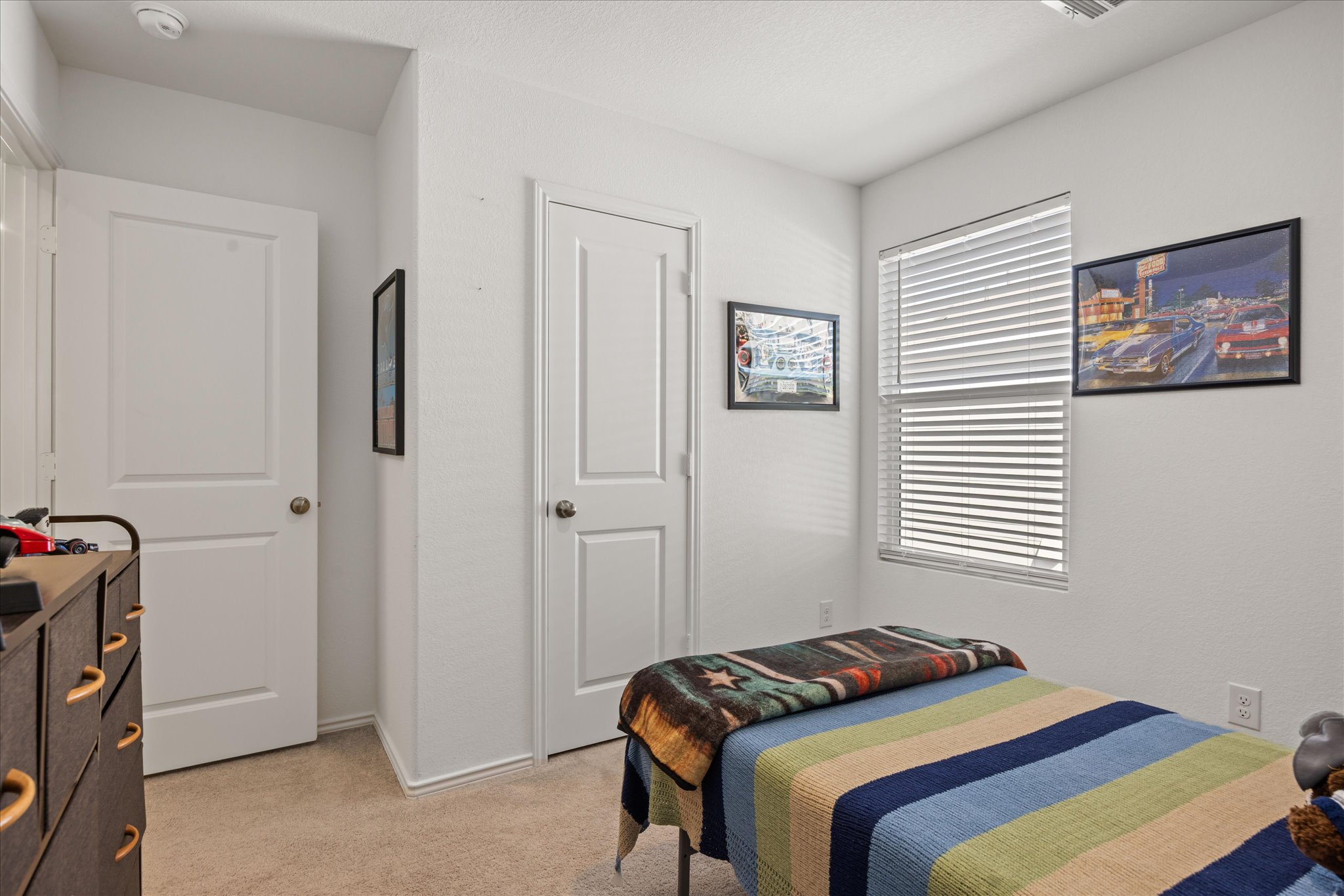 36 Trinity Circle Lockhart, TX 78644 - Photo 15 of 24 Plush carpeting and a large window bring warmth to this comfortable bedroom space.