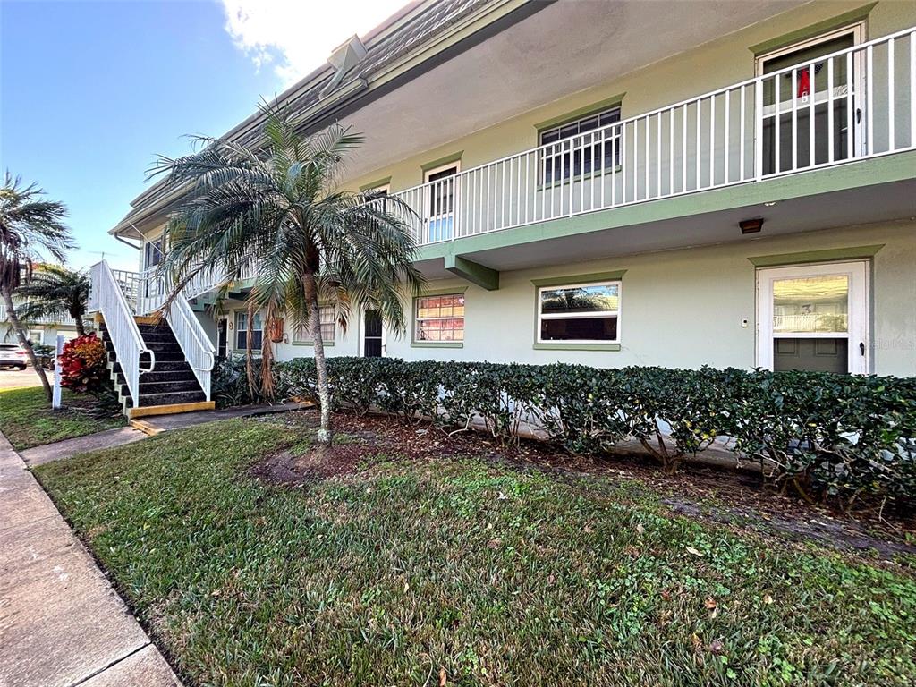 1433 South Belcher Road, Unit B2 Clearwater, FL 33764 - Photo 2 of 20 a front view of house with yard