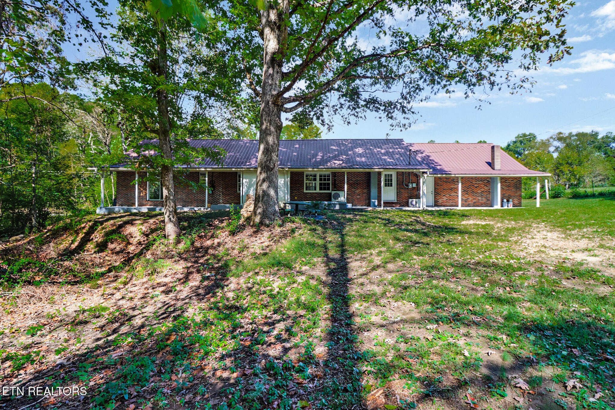 1271 Gouldstown Road Jamestown, TN 38556 - Photo 2 of 52 a front view of a house with a garden