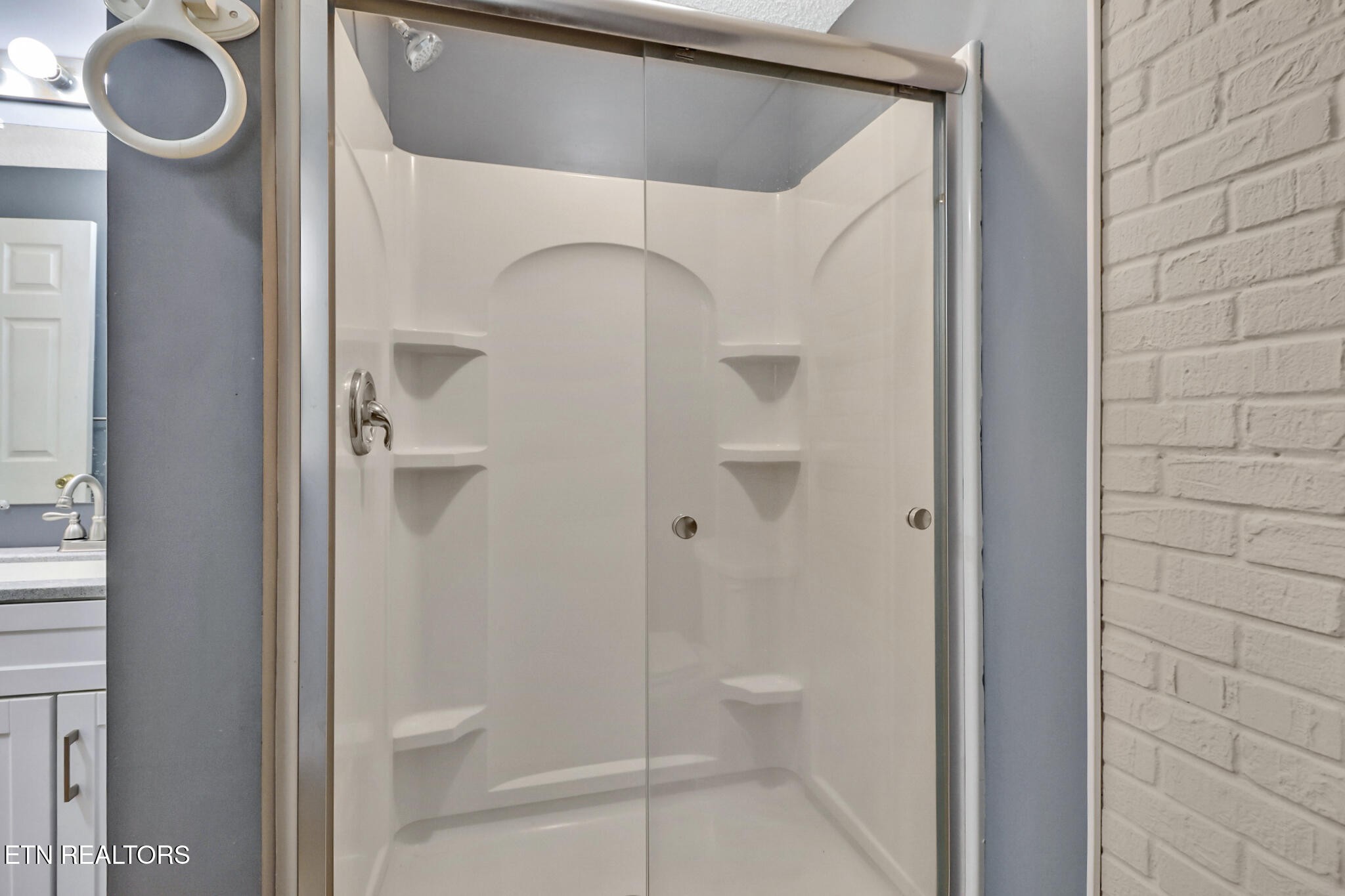 1271 Gouldstown Road Jamestown, TN 38556 - Photo 22 of 52 a bathroom with a granite countertop mirror and a shower