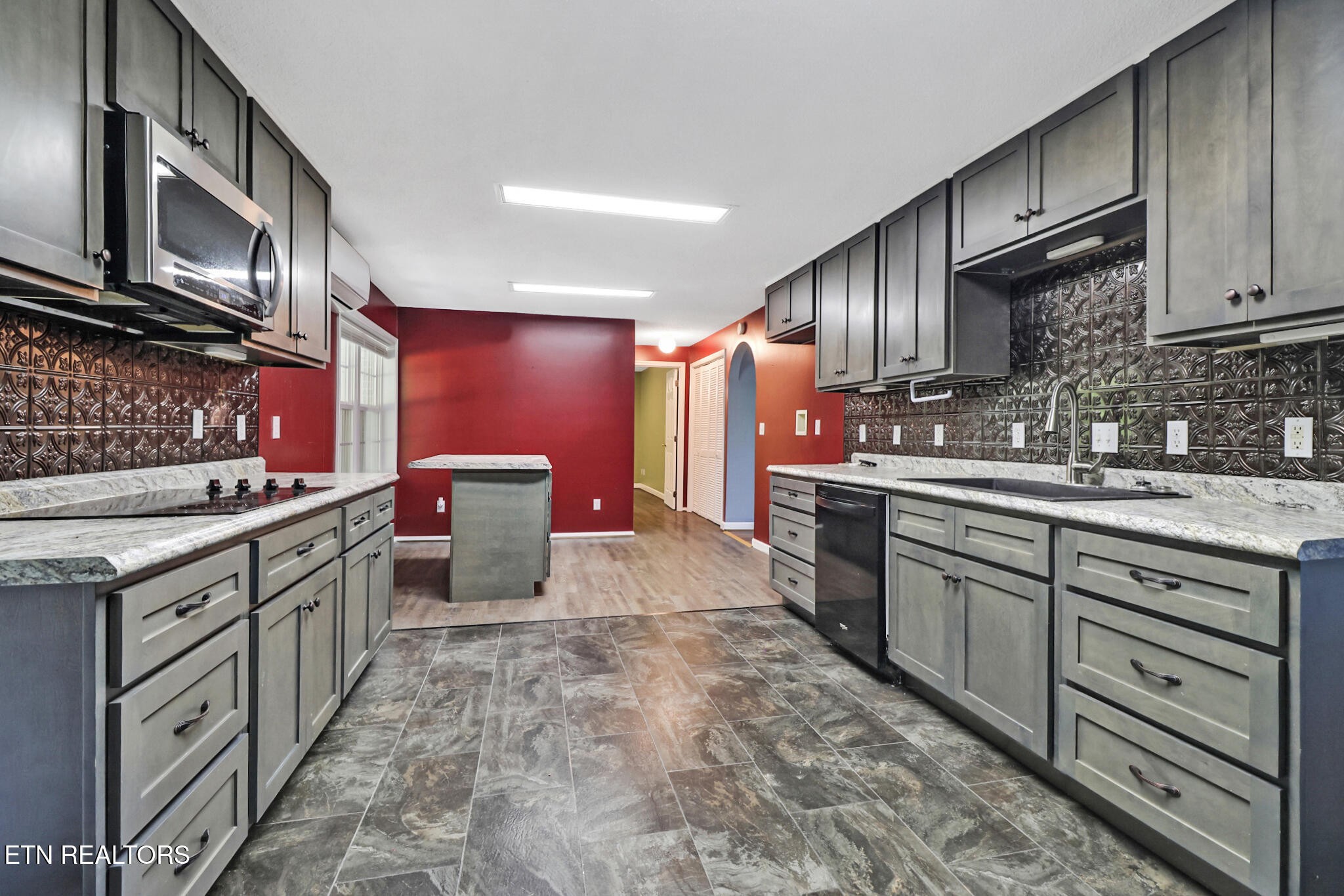 1271 Gouldstown Road Jamestown, TN 38556 - Photo 24 of 52 a kitchen with stainless steel appliances granite countertop a sink stove and cabinets