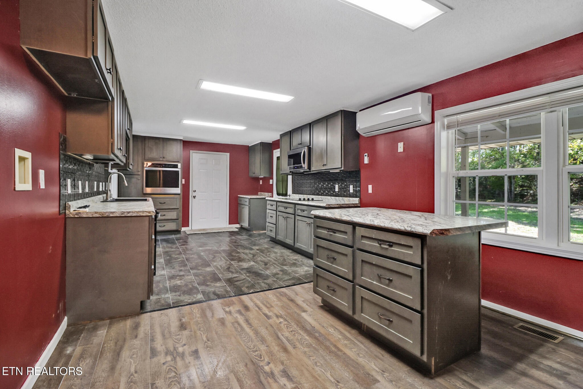 1271 Gouldstown Road Jamestown, TN 38556 - Photo 25 of 52 a kitchen with stainless steel appliances kitchen island granite countertop a stove and a sink