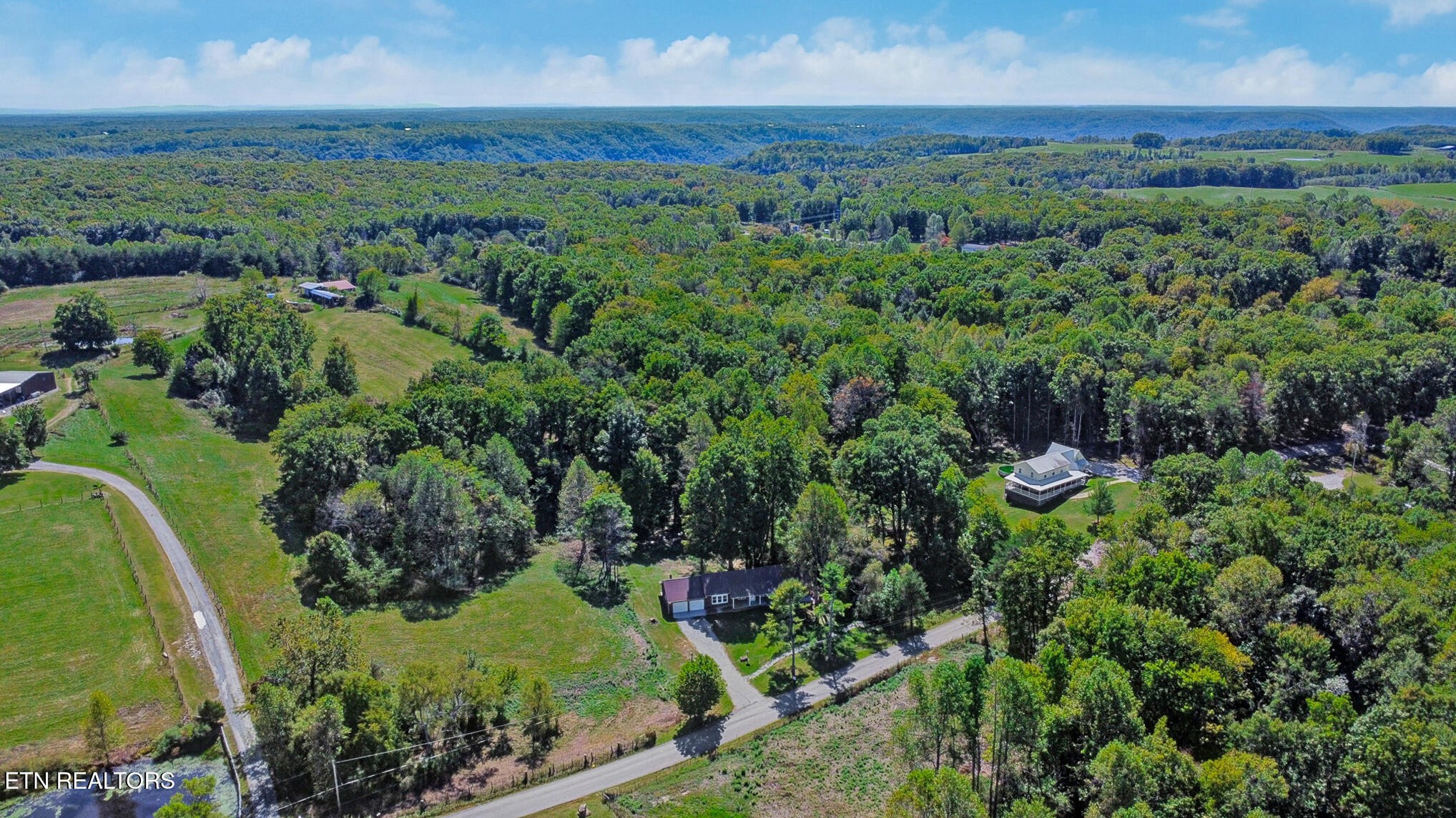 1271 Gouldstown Road Jamestown, TN 38556 - Photo 45 of 52 an aerial view of green landscape with trees houses and mountain view