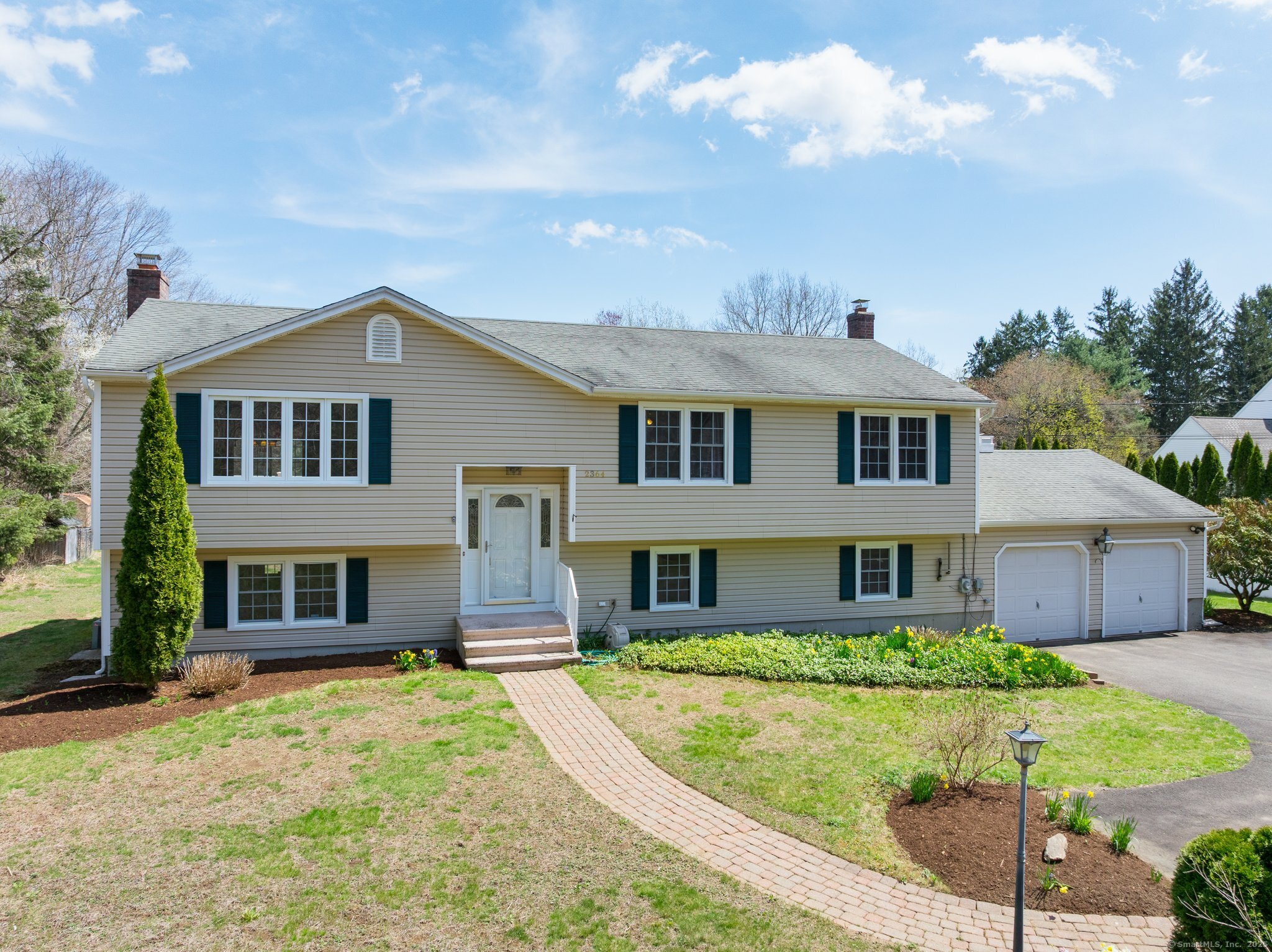 a front view of a house with a garden