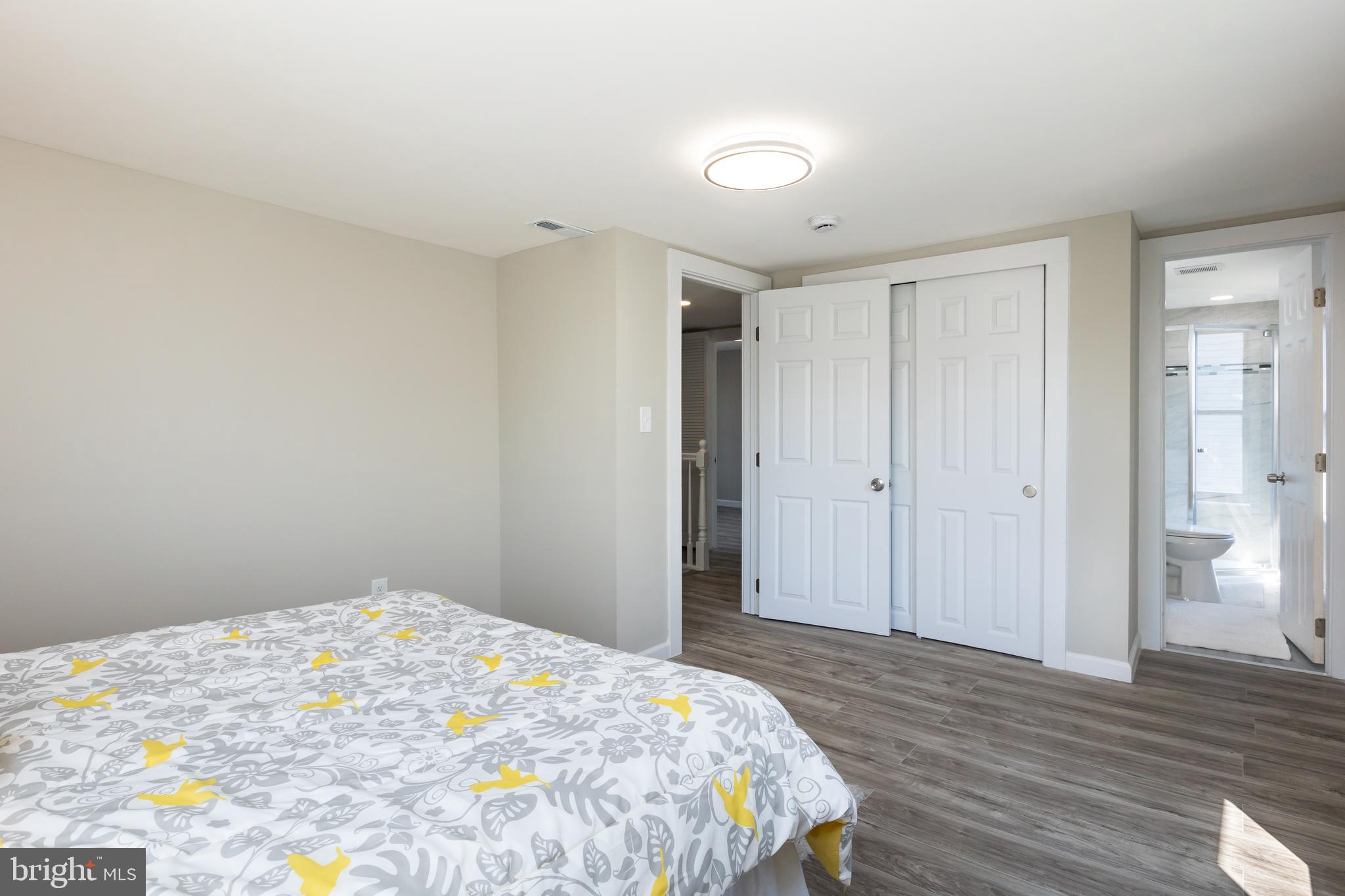 2407 Hammonds Ferry Road Halethorpe, MD 21227 - Photo 26 of 43 a bedroom with a bed and wooden floor
