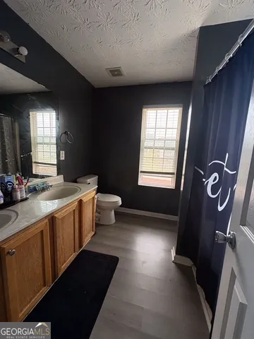 a bathroom with a double vanity sink toilet and shower