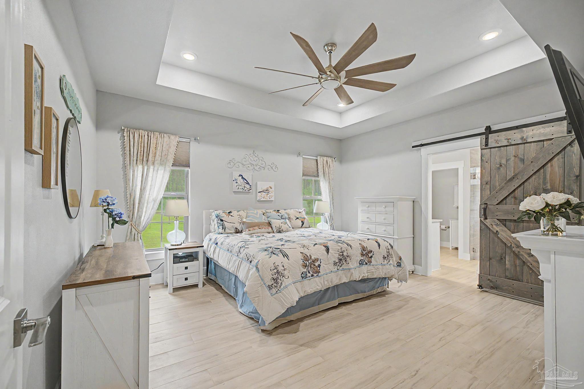 1918 Pineview Church Road Jay, FL 32565 - Photo 13 of 45 a bedroom with a large bed and a chandelier