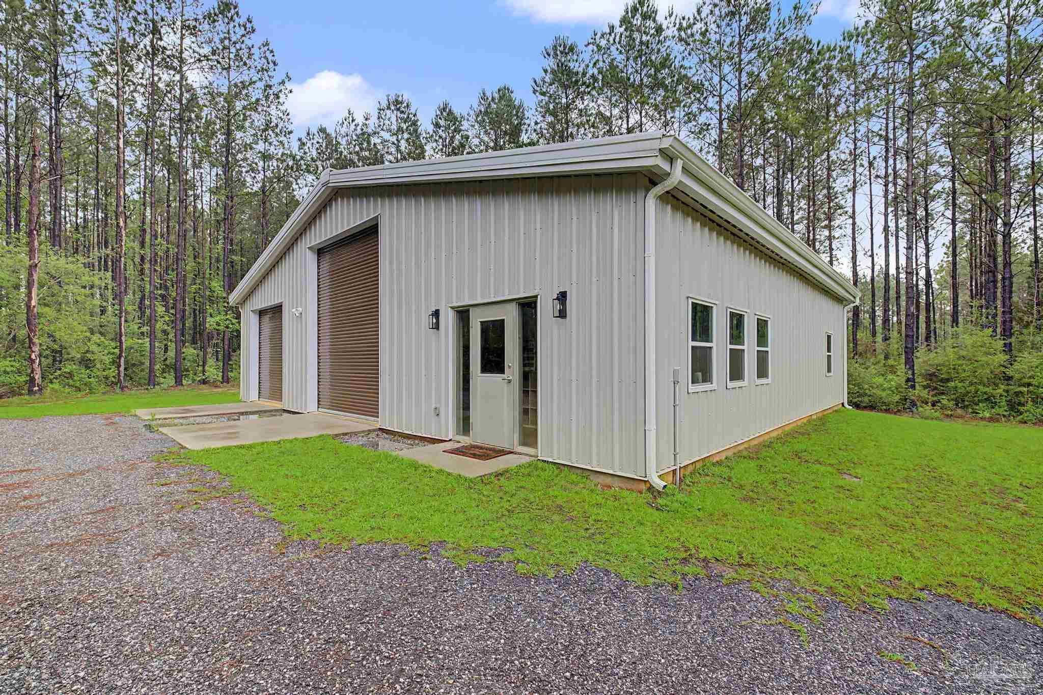 1918 Pineview Church Road Jay, FL 32565 - Photo 34 of 45 a view of a white house with yard and a yard