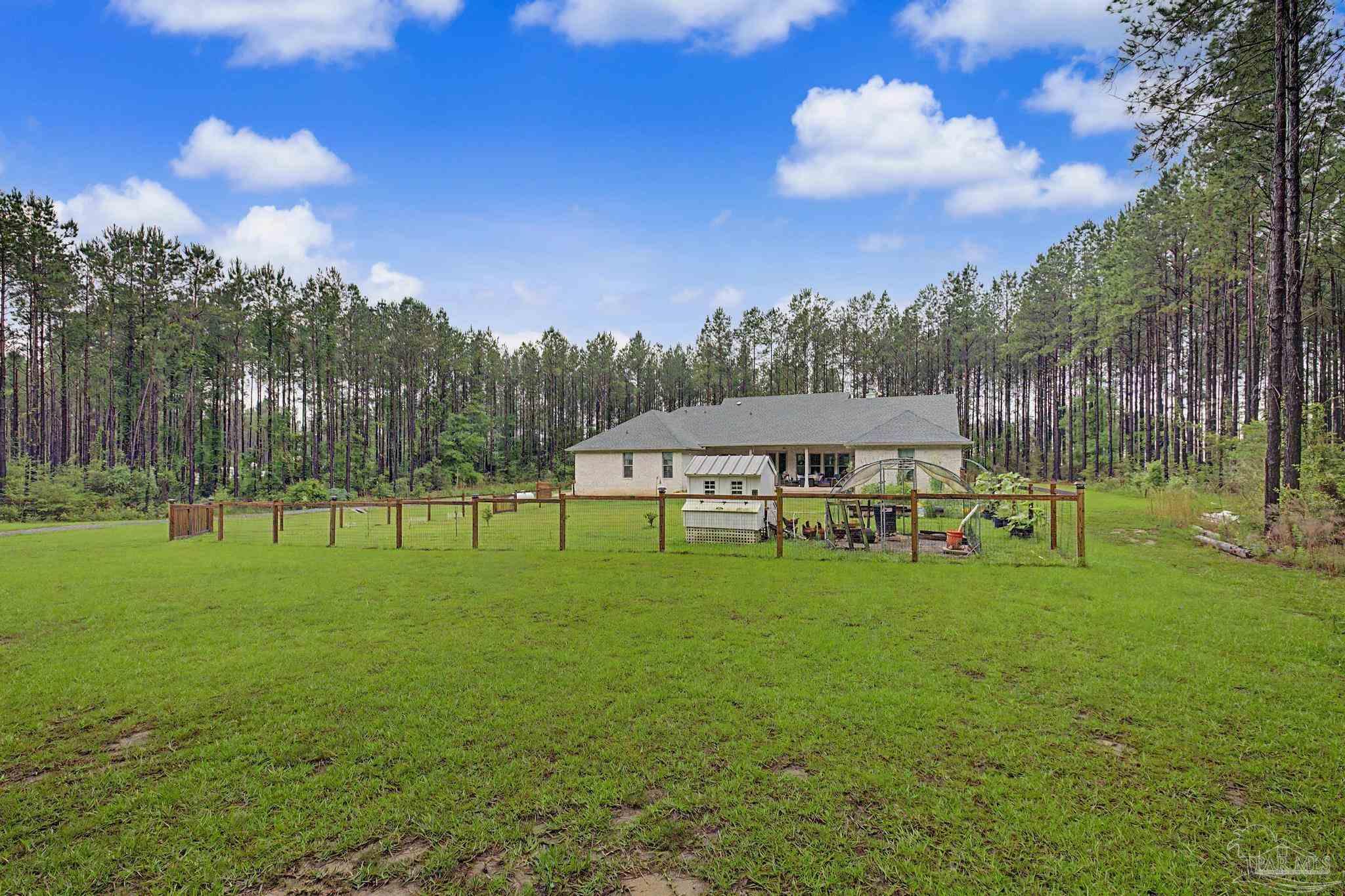 1918 Pineview Church Road Jay, FL 32565 - Photo 43 of 45 a view of a big yard with a house in the background