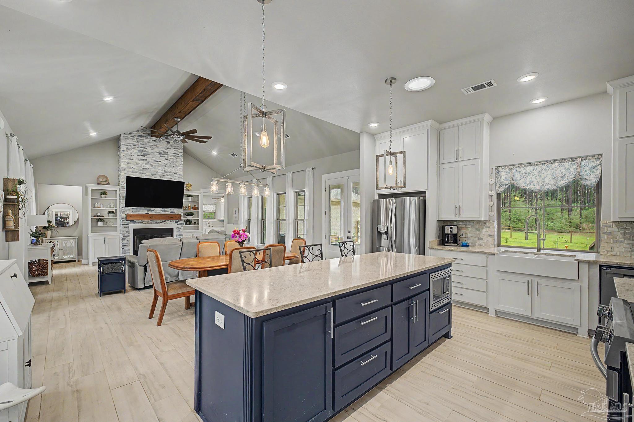 1918 Pineview Church Road Jay, FL 32565 - Photo 8 of 45 a large kitchen with stainless steel appliances granite countertop a sink dishwasher a stove and a refrigerator with wooden floor