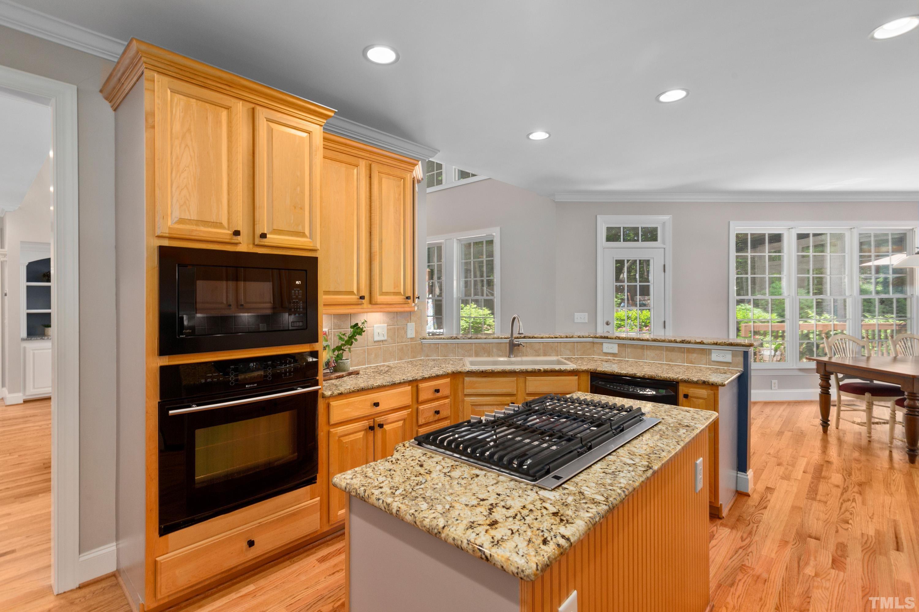 3728 Grandbridge Drive Apex, NC 27539 - Photo 18 of 76 a kitchen with a stove a sink and a microwave